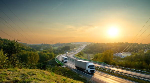 Photo of trucks traveling on a highway